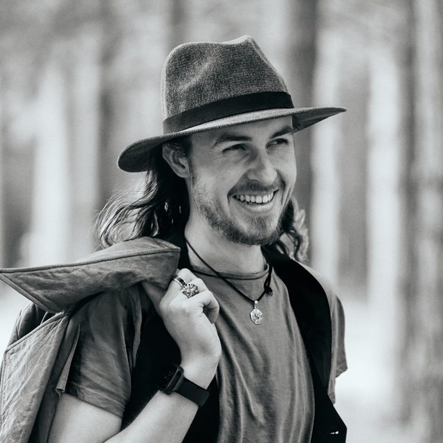 Llewellyn Craddock smiling, wearing a hat